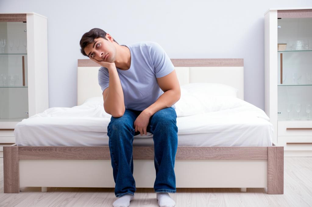 Illustration of a tired office worker slumped over a desk, looking drained and lacking energy.