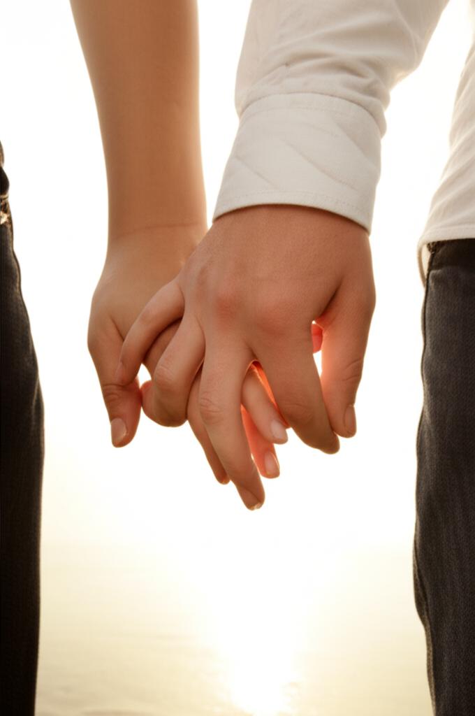 Couple holding hands happily, symbolizing restored intimacy