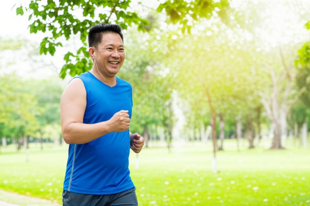 A Thai man in his 40s looking healthy and energetic, perhaps jogging or working confidently at a desk.
